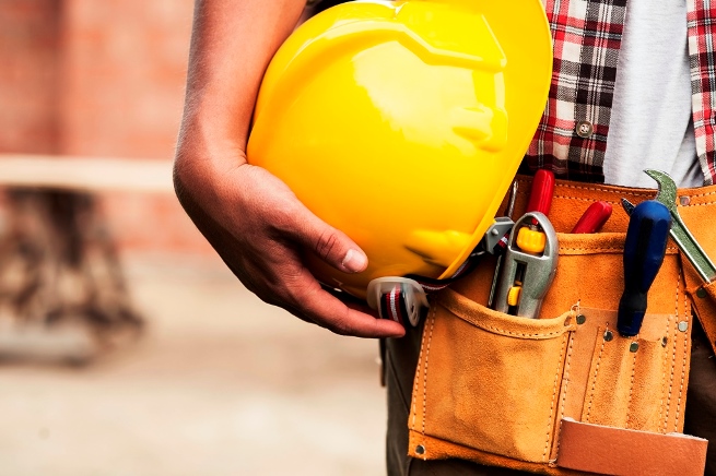 Construction worker holding a hard hat